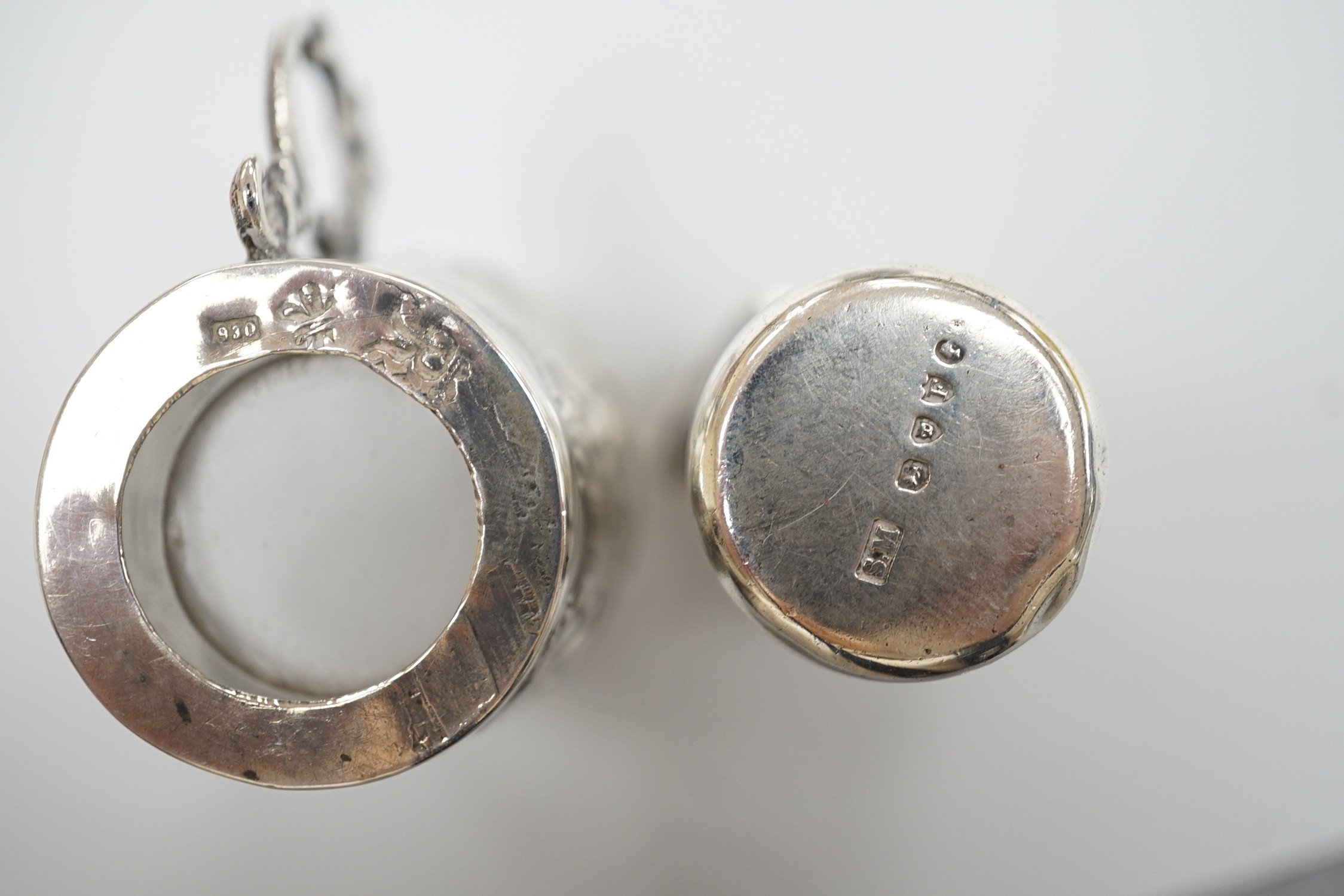 A late Victorian aesthetic engraved silver cylindrical scent bottle, by Sampson Mordan, London, 1881, 54mm, two other mounted glass scent bottles and a similar silver mounted demi tasse cup.